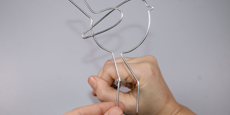 Auch das zweite Bein abwinkeln. Figuren aus Aluminiumdraht
