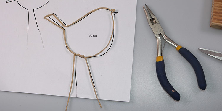 So sieht der fertige Vogel aus. Er kann nun auf das Papier geklebt werden. Vogel aus Papierdraht biegen